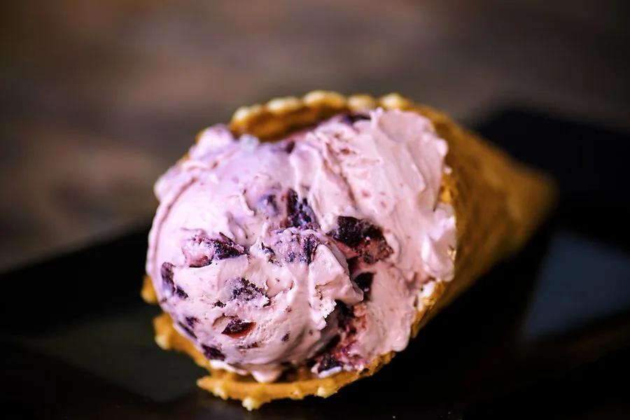 Amaretto Bordeaux cherry ice cream in a waffle cone