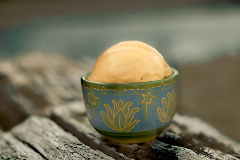 Orange sherbet in a painted bowl